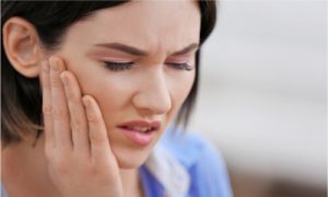 How can I treat a bone spur in my mouth?